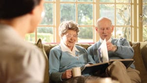 An elderly couple looking through a photo album