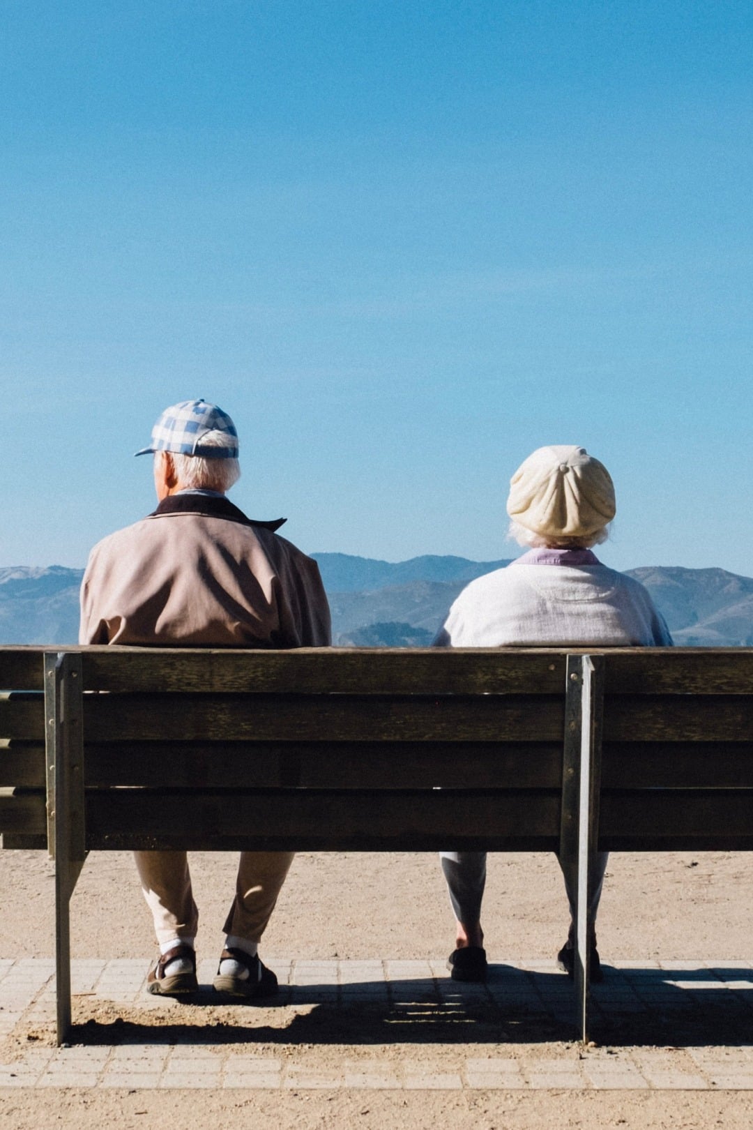 elderly couple sitting on a bench, representing cerebral palsy care