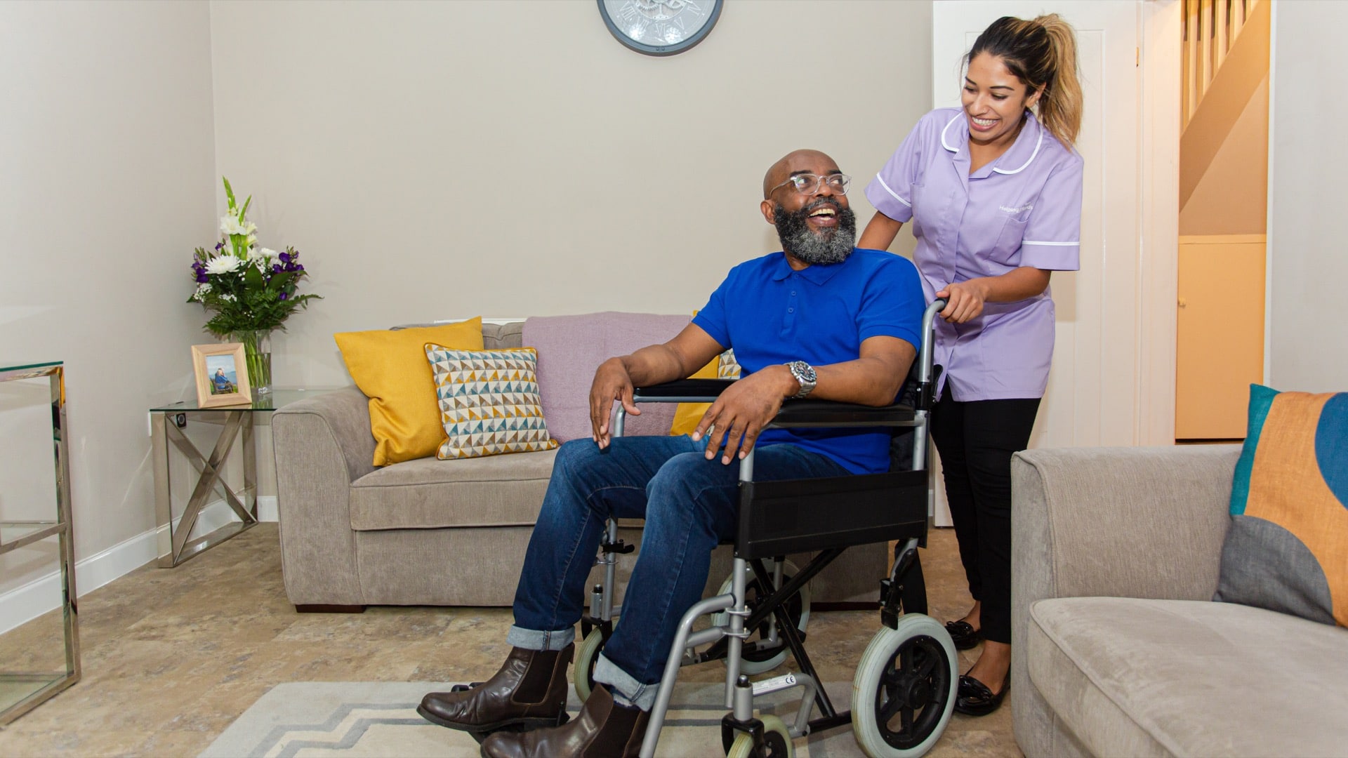 a women working in respite care helping a man in a wheelchair