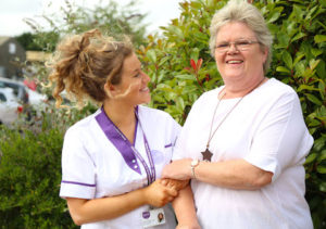 Visiting carer and customer laughing